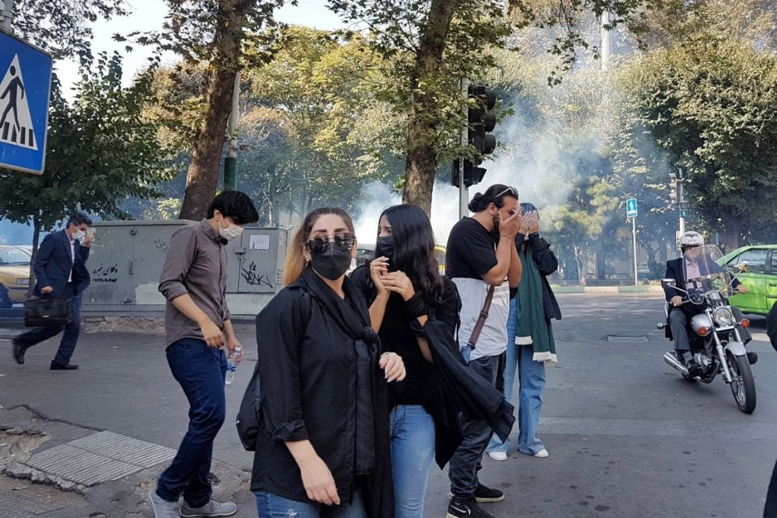 Protesters in Tehran, Iran run away as security forces throw tear gas during a protest on Sunday over the death of Iranian woman Mahsa Amini, who died last week after being arrested in Tehran for not wearing her hijab appropriately. Photo: EPA-EFE