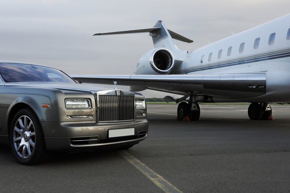 Private executive airplane with limousine Rolls Royce Phantom luxury car shown together at an airport runway. Photo: Shutterstock