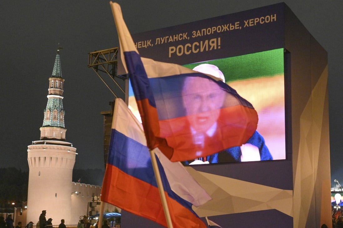 People in Moscow watch a large screen, as Russian President Vladimir Putin speaks during celebrations marking the incorporation of regions of Ukraine to join Russia. Photo: AP