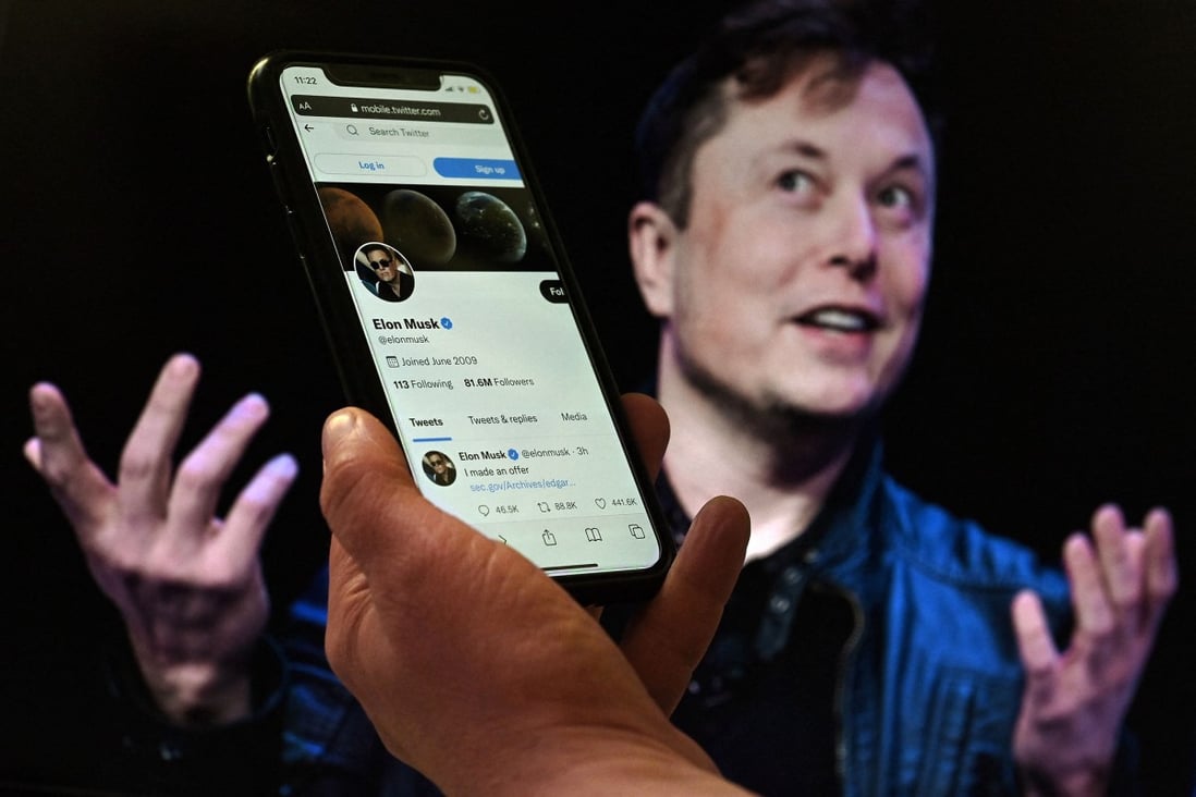In this photo illustration, a phone screen displays the Twitter account of Elon Musk with a photo of him shown in the background, on April 14, 2022. Photo: AFP