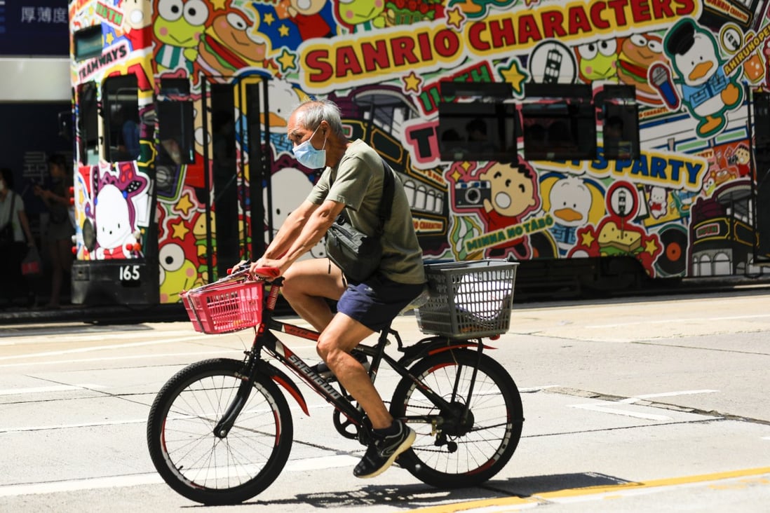 A man rides a bicycle through Causeway Bay on September 15. Keeping elderly people physically and socially active could help Hong Kong ease some of the costs of its increasingly aged population. Photo: Xiaomei Chen