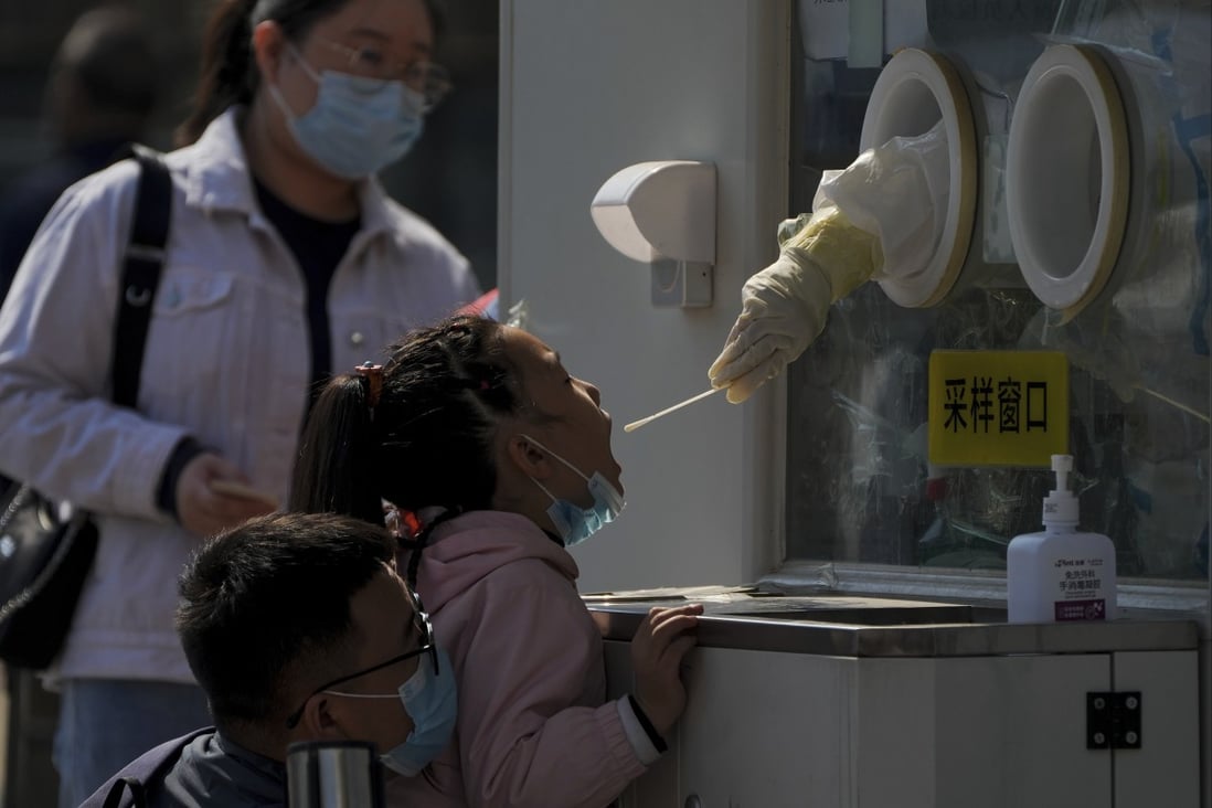 A child gets her routine Covid-19 throat swab at a coronavirus testing site in Beijing on Thursday. Photo: AP Photo