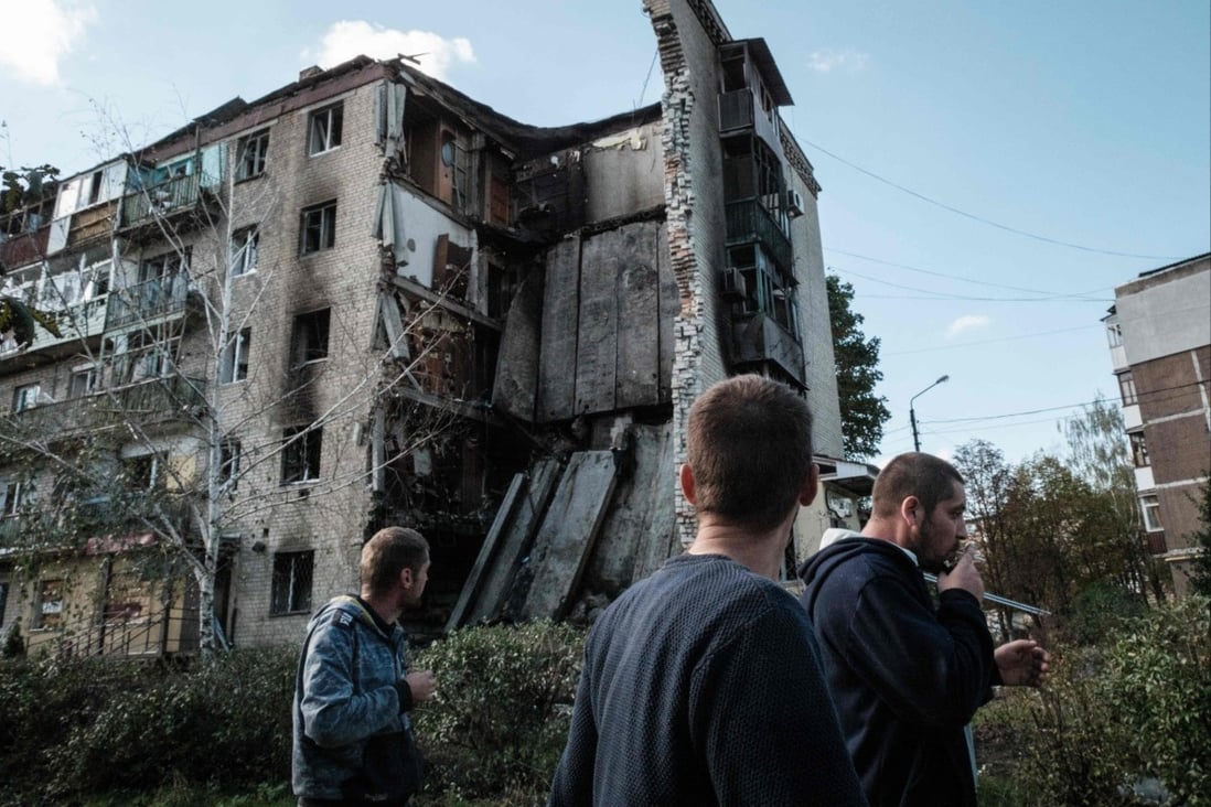 Residents look at a destroyed building in Bakhmut, eastern Ukraine on Friday. Photo: AFP