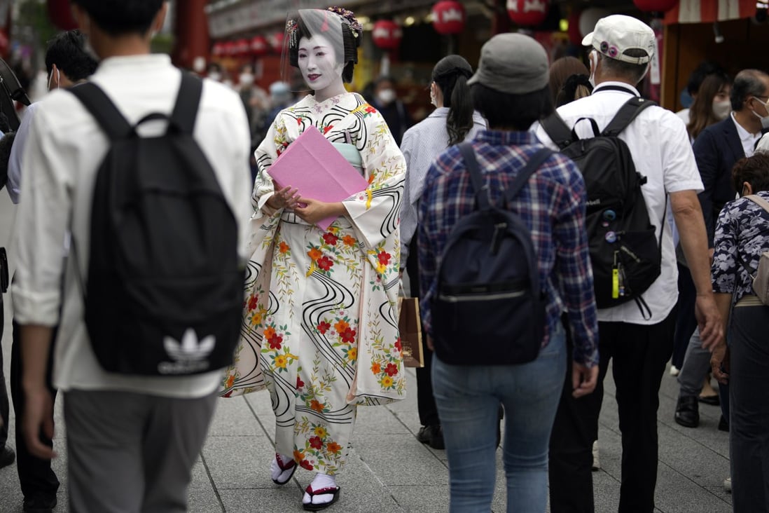 A geisha walks along a Tokyo street. Photo: AP