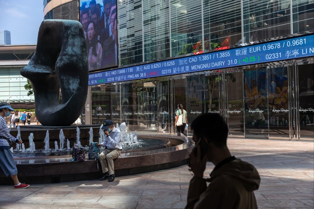 Pedestrians walk past a stock ticker displaying the Hang Seng Index in Hong Kong on October 11. Photo: EPA-EFE