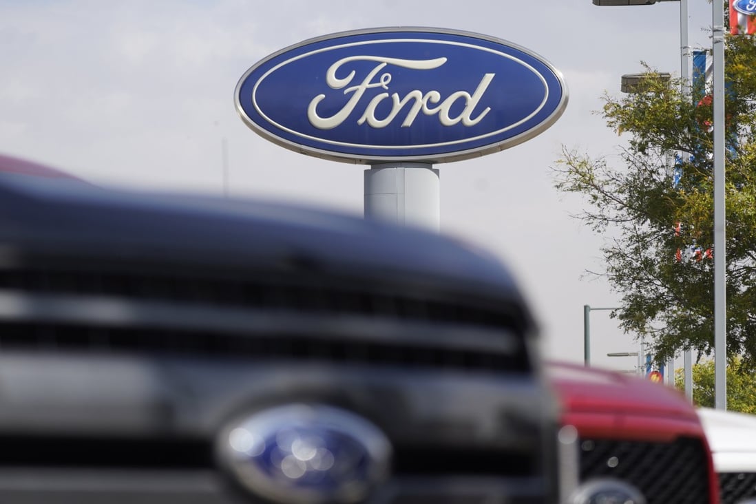 In this Oct. 11, 2020, file photo, the Ford logo hangs over a row of 2020 F-150 pickup trucks in Denver. Photo: AP 