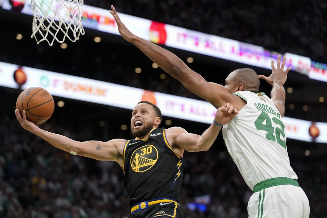 Golden State Warriors guard Stephen Curry goes up for a shot against Boston Celtics centre Al Horford. Photo: AP