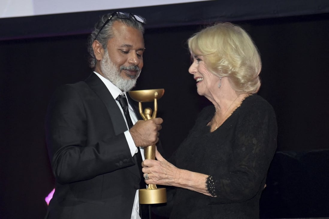 Britain’s Camilla, Queen Consort, presents Booker Prizer winner Shehan Karunatilaka with the trophy for The Seven Moons of Maali Almeida at the Roundhouse in London on Monday. Photo: AP