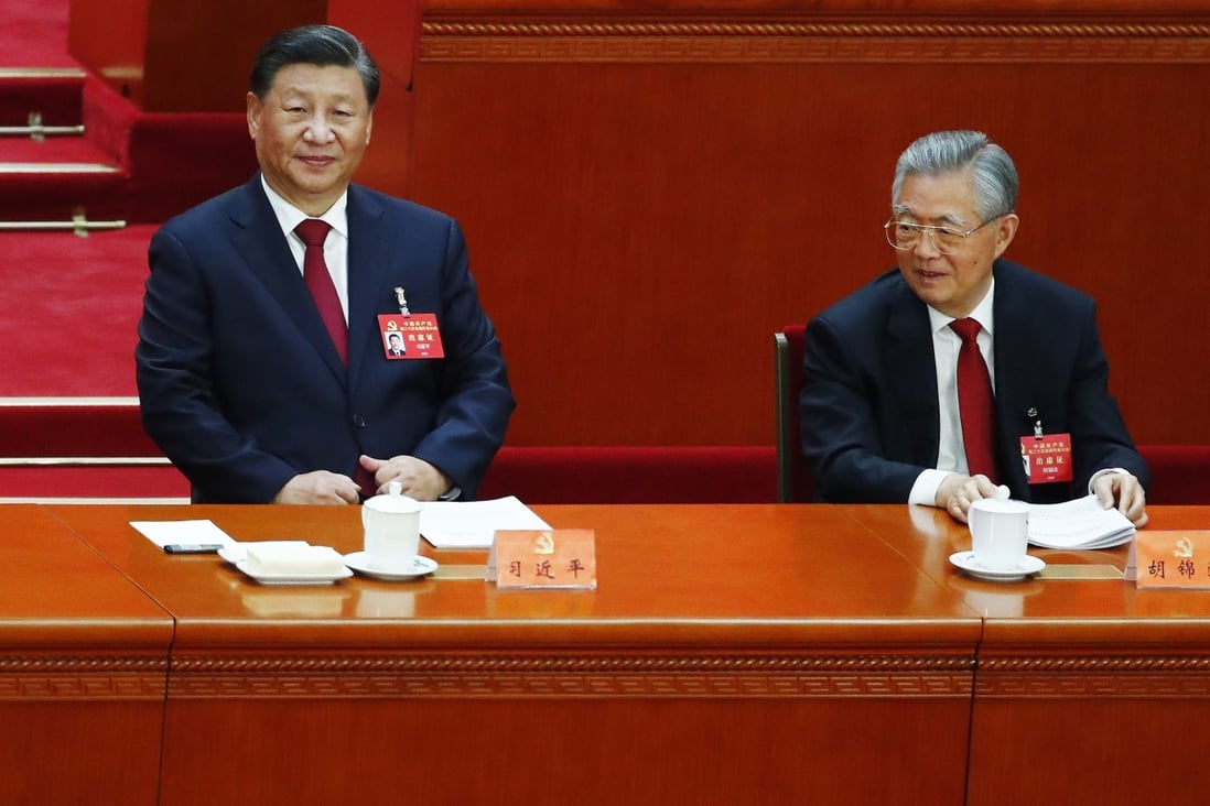 Former president Hu Jintao (right) took his seat beside his successor Xi Jinping on Sunday morning.  Photo: EPA-EFE