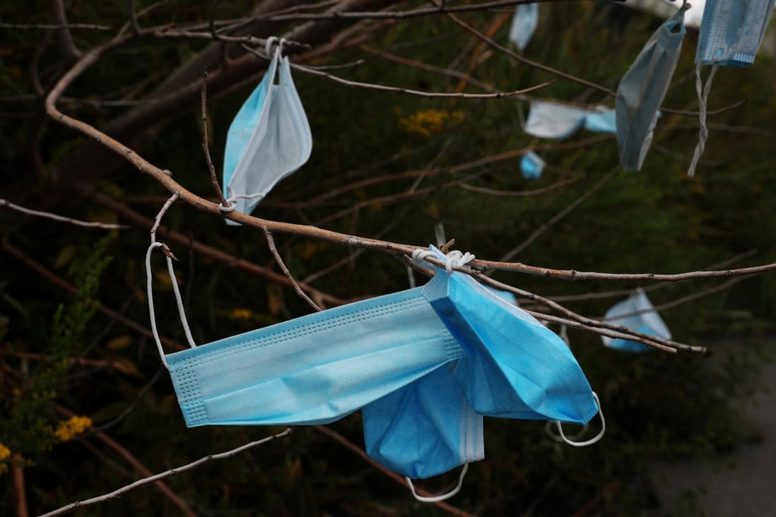 Face masks hang on trees on the entrance road to the Vernon C. Bain Correctional Detention Centre jail barge in New York on Monday. Photo: Reuters