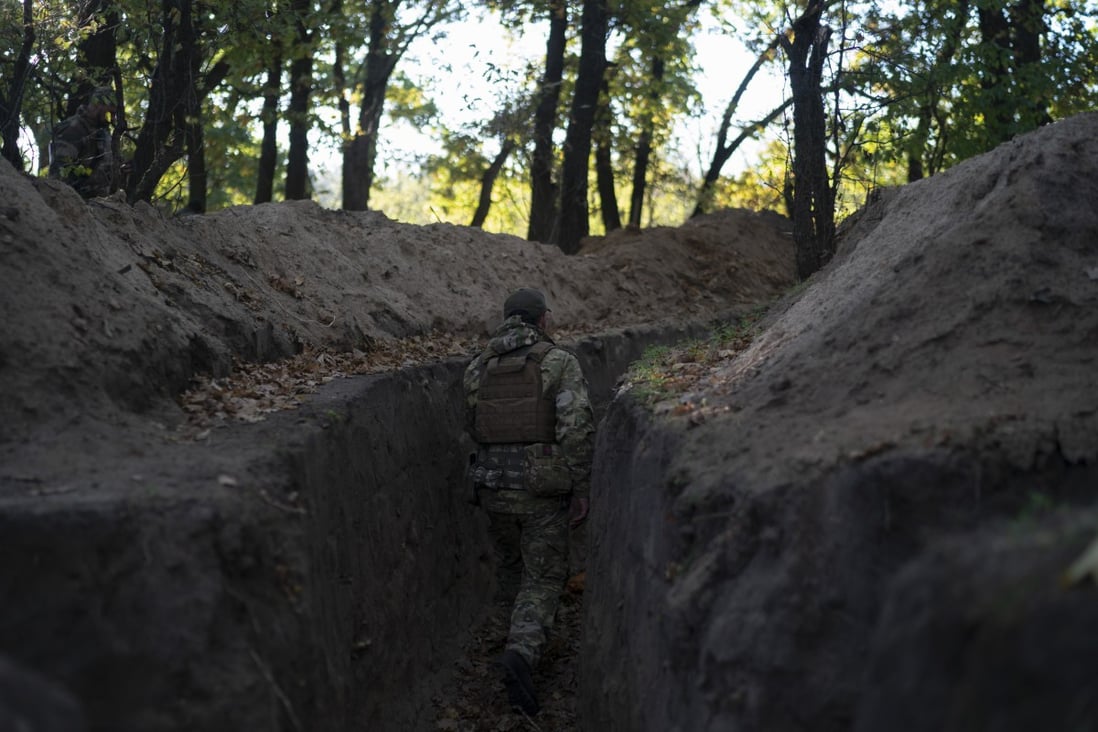 A Ukrainian serviceman checks the trenches dug by Russian soldiers in a retaken area in the Kherson region, Ukraine. Photo: AP