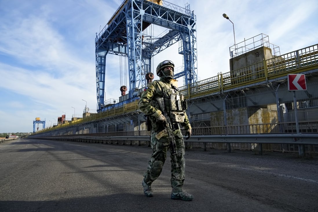 A Russian soldier patrols at the Kakhovka hydroelectric power plant on the Dnieper River in Kherson region. File photo: AP