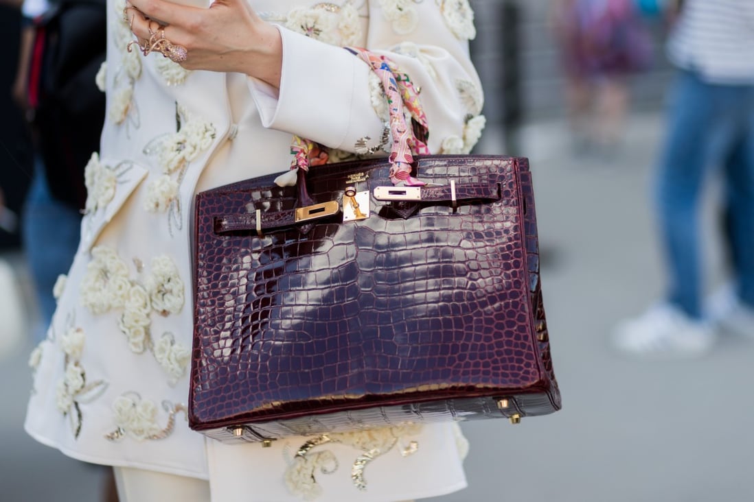 A woman wears a Hermès bag during Paris Fashion Week. The French luxury-goods company is set to increase its prices by between five per cent and 10 per cent in January. Photo: Getty Images