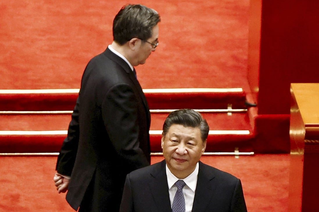 Ding Xuexiang passes behind President Xi Jinping at the opening session of the annual meeting of the Chinese People’s Political Consultative Conference at the Great Hall of the People in Beijing on March 4. Photo: Reuters