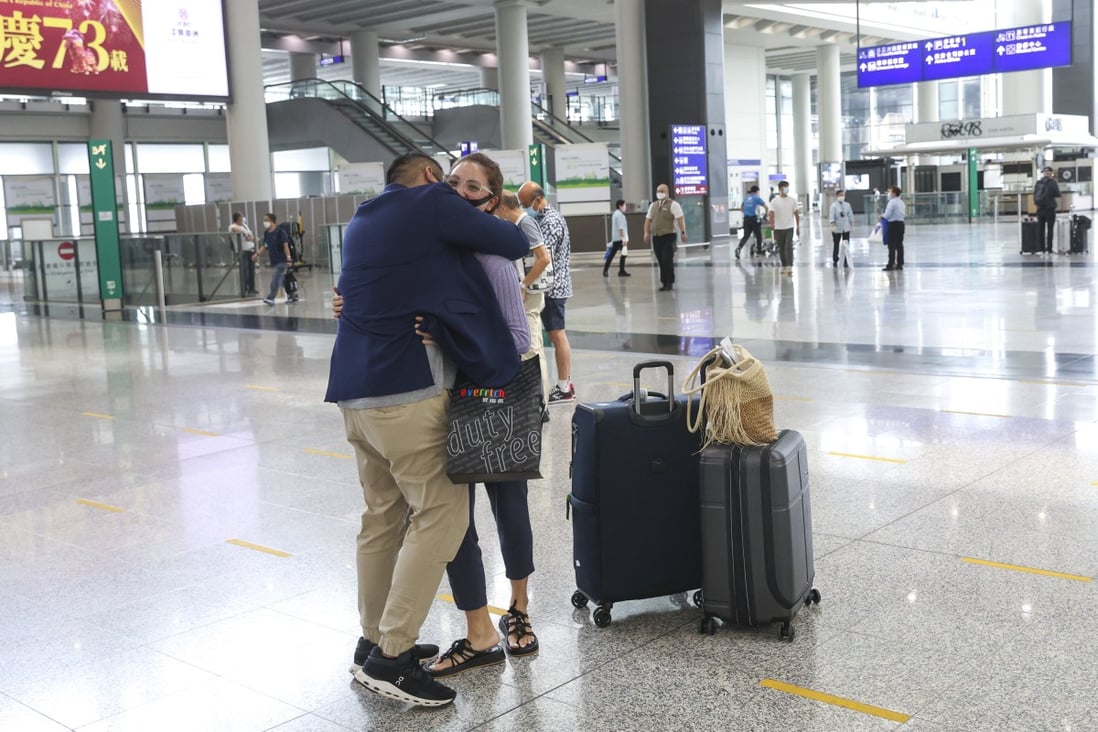 A traveller hugs a loved one at the arrivals hall of the Hong Kong International Airport on September 27, 2022 after the city lifted its hotel quarantine requirement. Photo: SCMP / Yik Yeung-man