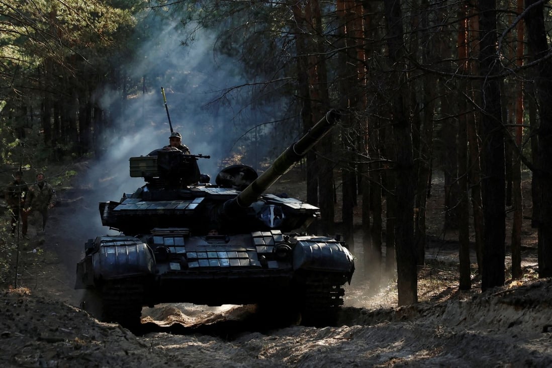 Ukrainian soldiers drive a captured Russian tank in the Kupiansk region of Kharkiv Oblast on October 15. Photo: Reuters