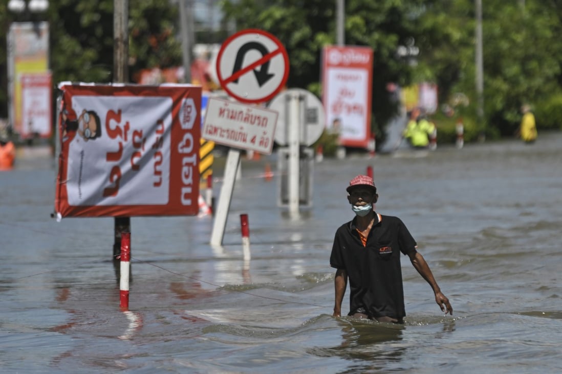 A resident wades through floodwaters in Ubon Ratchathani province, northeastern Thailand, on October 5, 2022. Worsening climate change is expected to lead to more frequent and deadly floods, fires and storms, experts say. Photo: AP Photo