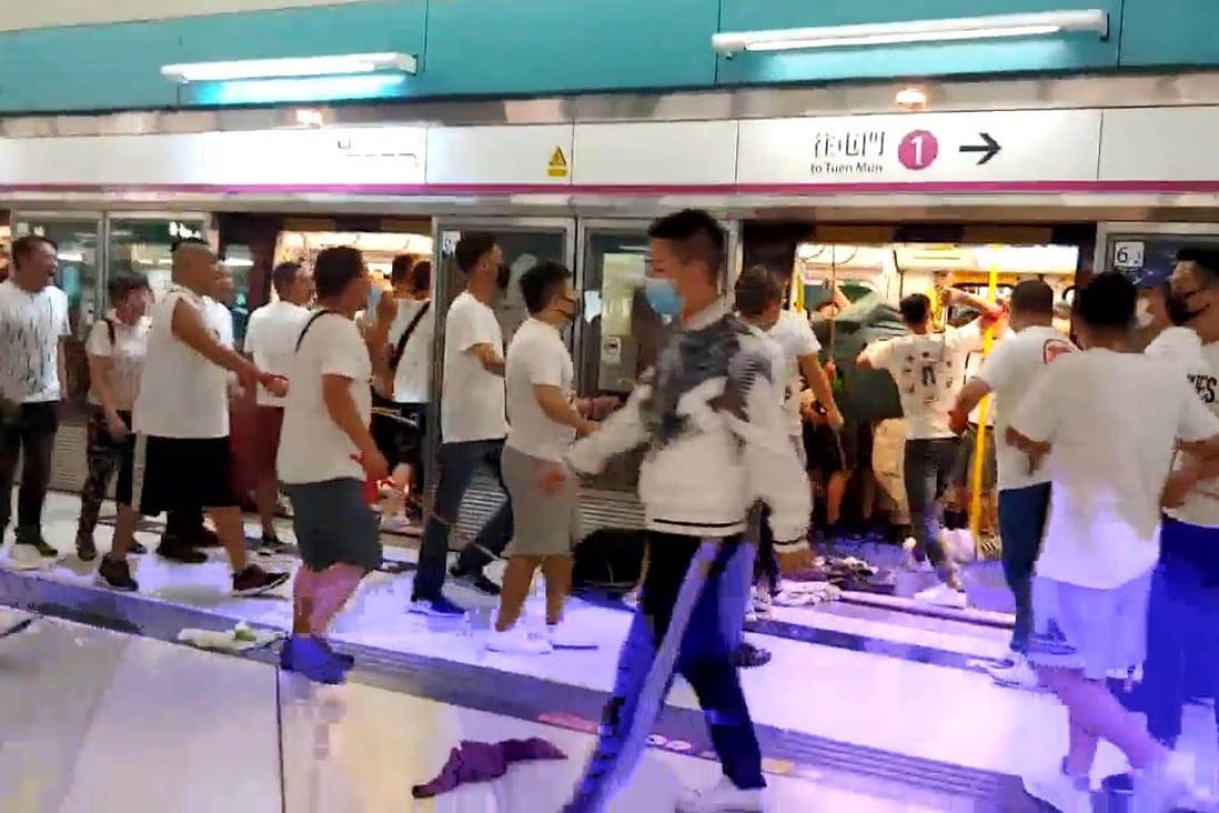 A mob of men in white T-shirts attacked black-clad protesters and passengers on a late night train after protesters were returning to the Yuen Long MTR Station. Photo: Handout