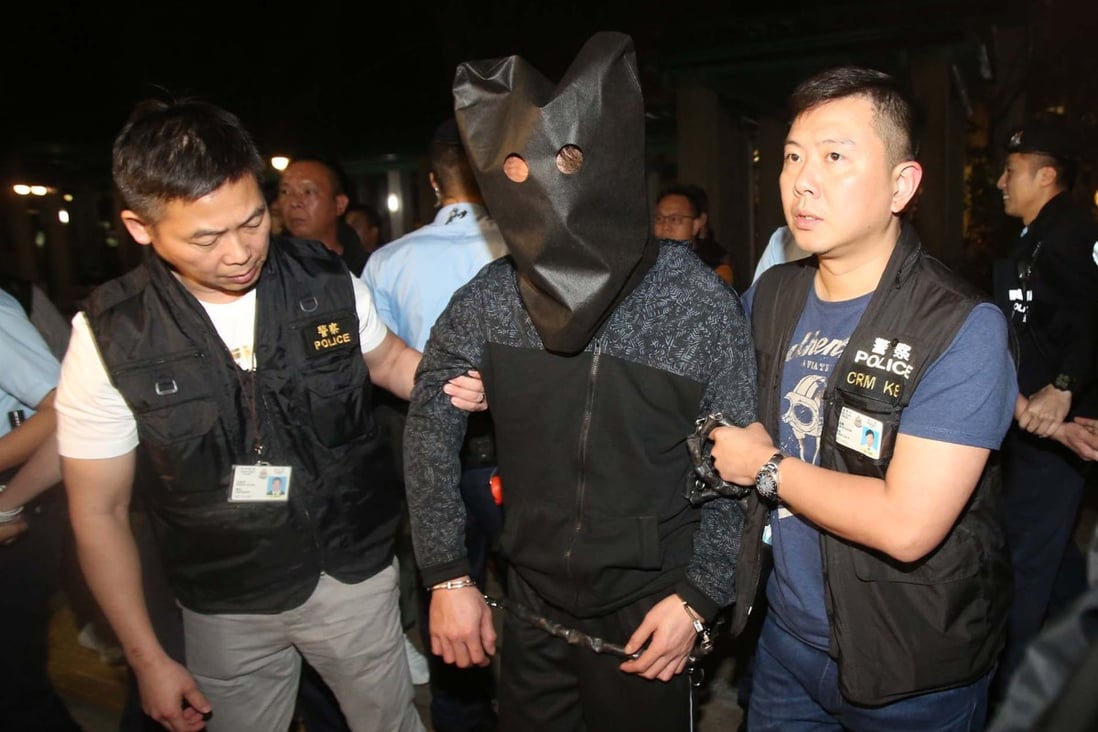 Police escorting the suspect in 2019 at Po Lam Estate. Photo: Handout