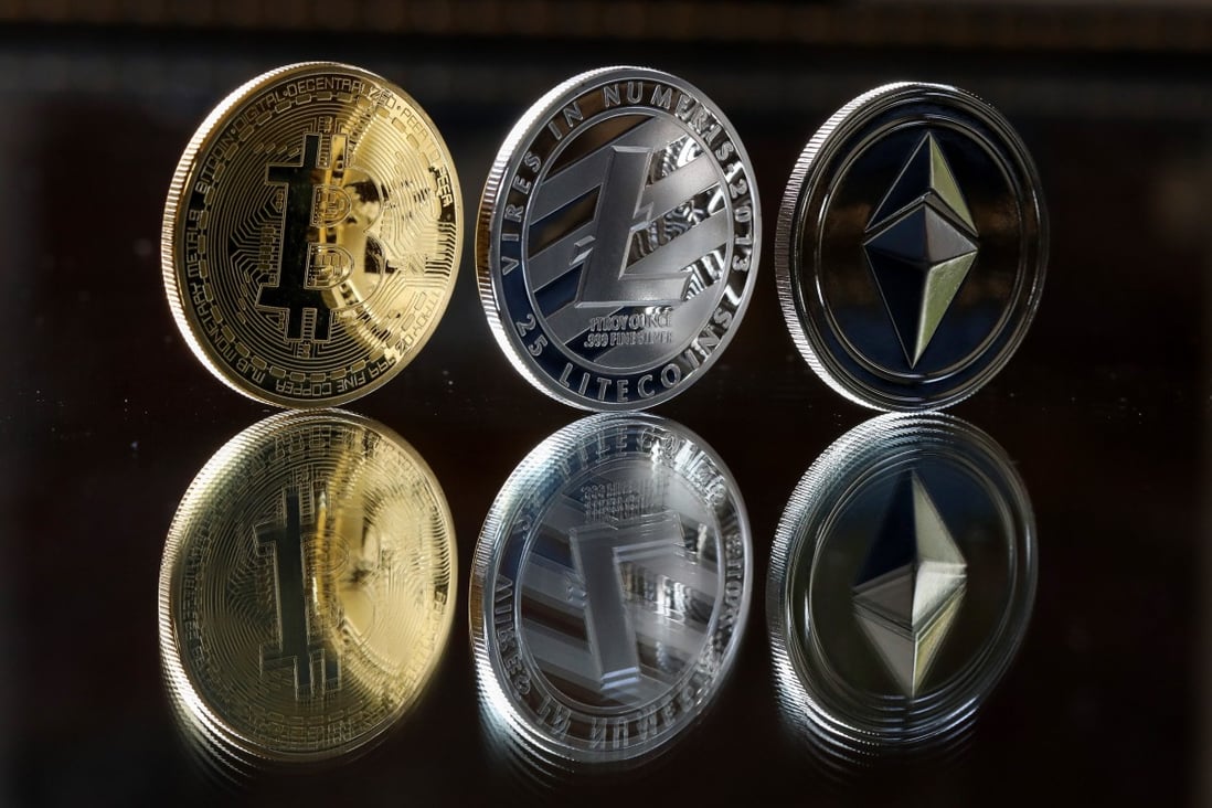 A bitcoin token, left, a litecoin token, centre, and an ether token sit in this arranged photograph in Danbury, UK, on October 17, 2017. Photo: Bloomberg