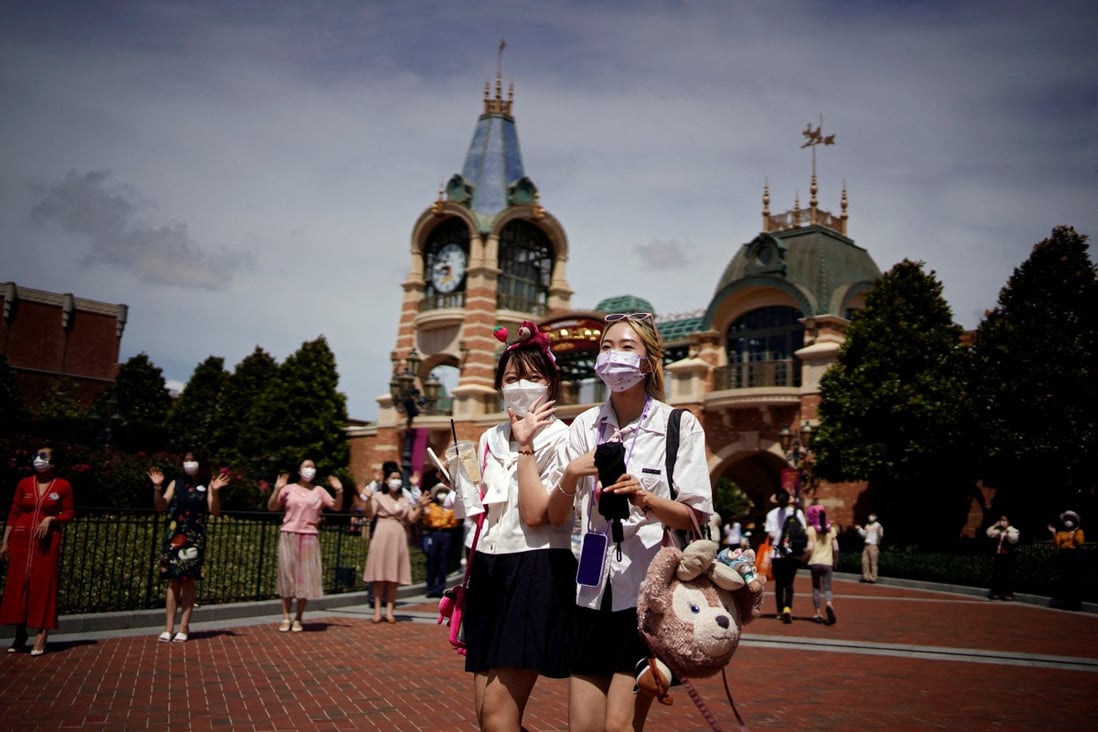 People wearing face masks visit the Shanghai Disney Resort as it reopens on June 30, 2022 following a long Covid-19 closure. Photo: Reuters