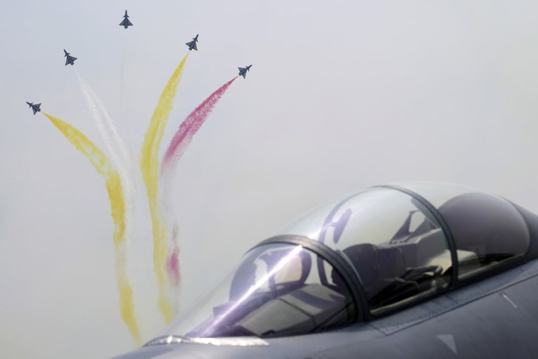 Members of the “August 1st” Aerobatic Team of the PLA Air Force perform near a Chinese J-16D electronic warfare airplane during last year’s Zhuhai Airshow. Photo: AP