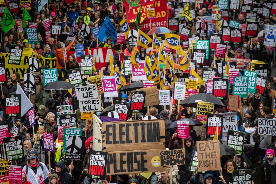 Protesters march with placards during the “Britain Is Broken” rally in London. Photo: Bloomberg