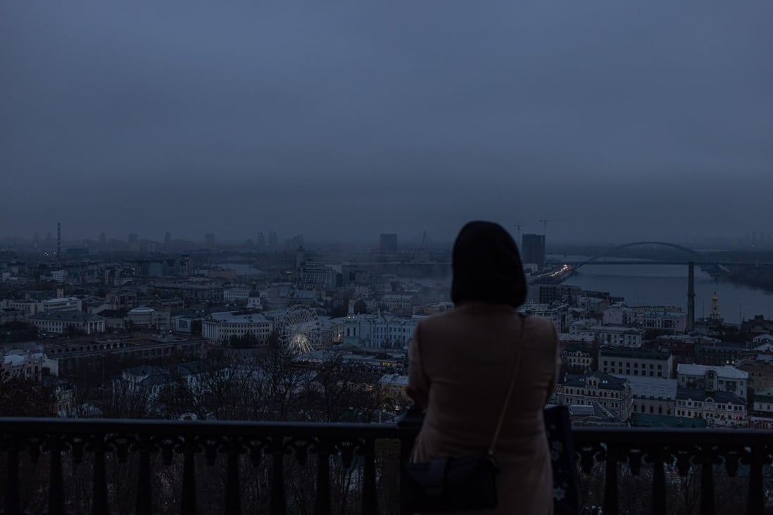 A woman looks out over Kyiv as blackouts continue. Photo: EPA-EFE
