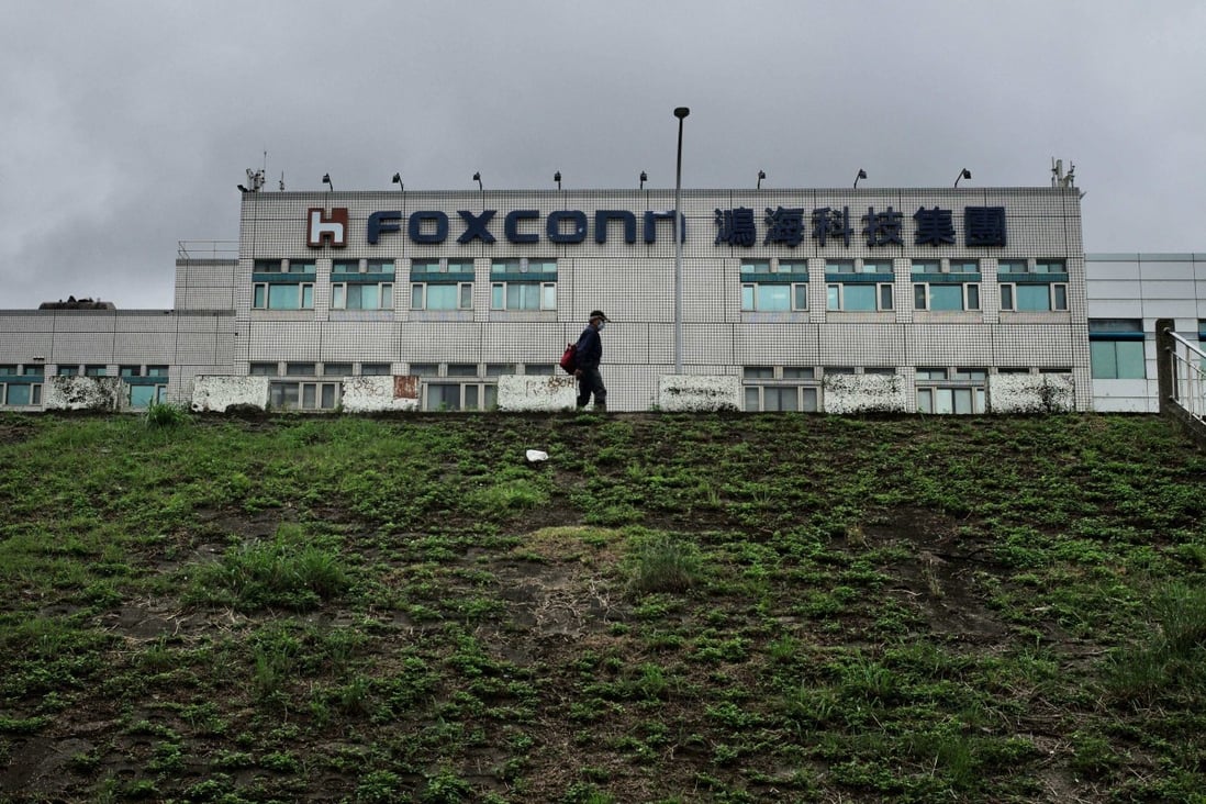 This file photo taken on May 6, 2022 shows a man walking past the Foxconn headquarters in New Taipei City, Taiwan. Photo: AFP