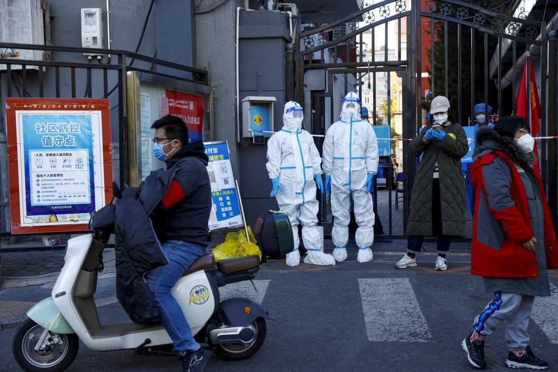 Security personnel in protective suits stand at the gate of a residential compound that is under lockdown as Covid-19 outbreaks continue in Beijing on October 22, 2022. Photo: Reuters