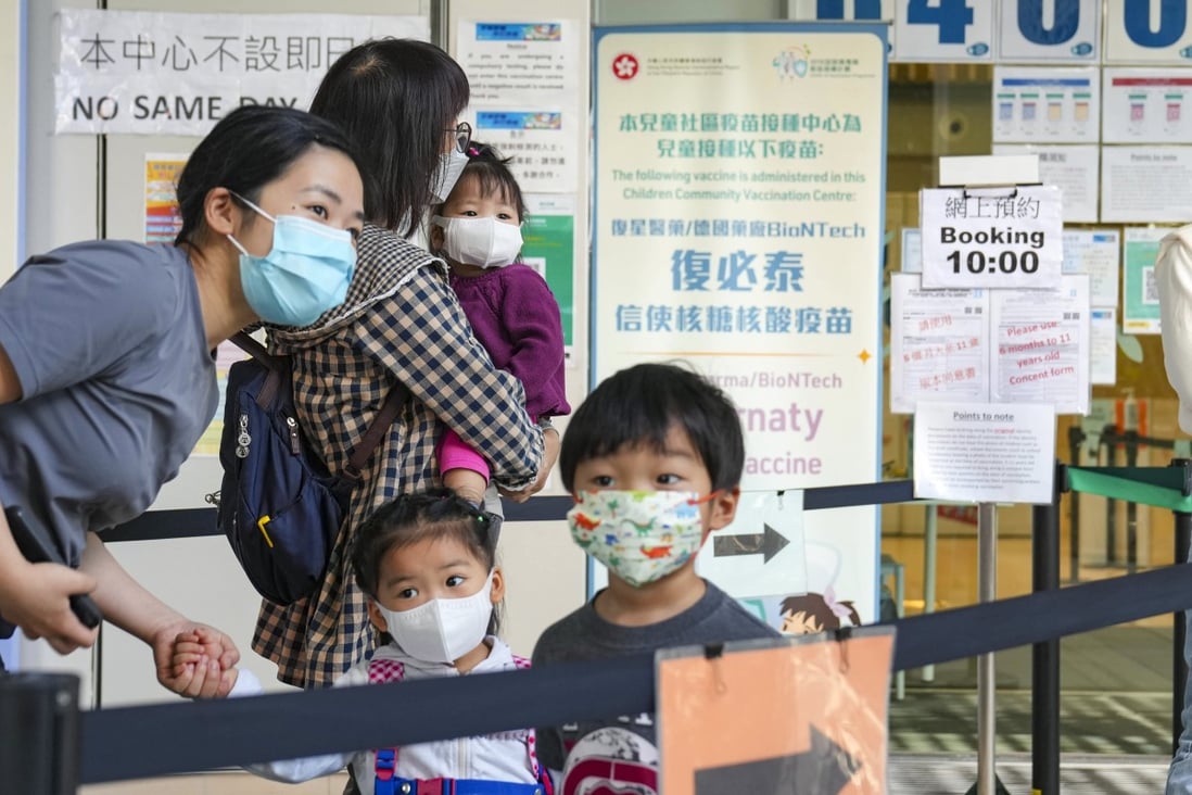 Parents bring their young ones to Hong Kong Children’s Hospital in Kai Tak on the first day of the BioNTech toddlers’ jab roll-out. Photo: Sam Tsang