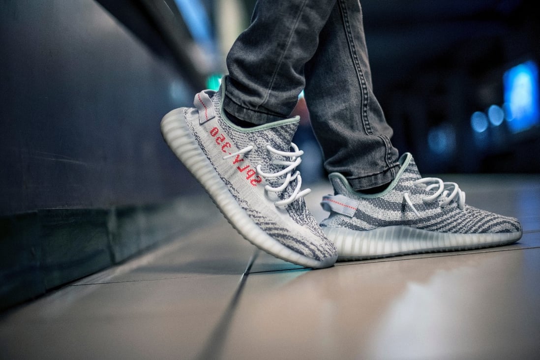 A man wears Adidas Yeezys in the subway in Milan, Italy. Adidas says ending its partnership with their designer, Ye, formerly Kanye West, will lower its profit margin on sales. Photo: Shutterstock