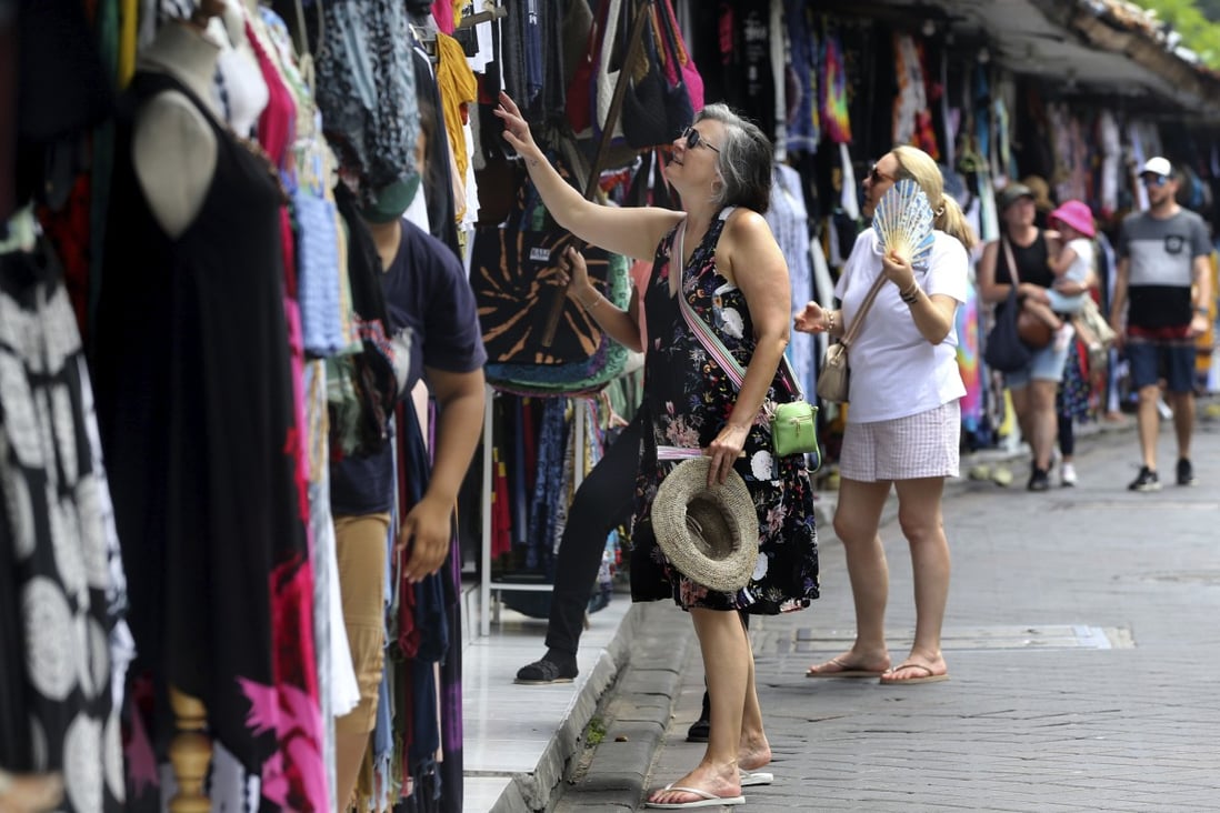 Foreign tourists shop for souvenirs in Bali, Indonesia on Saturday. Photo: AP