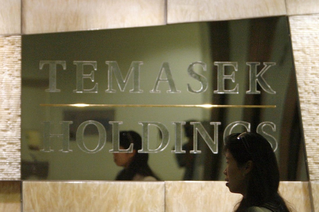 An employee walks past a Temasek Holdings sign at the company’s headquarters in Singapore. Photo: Reuters