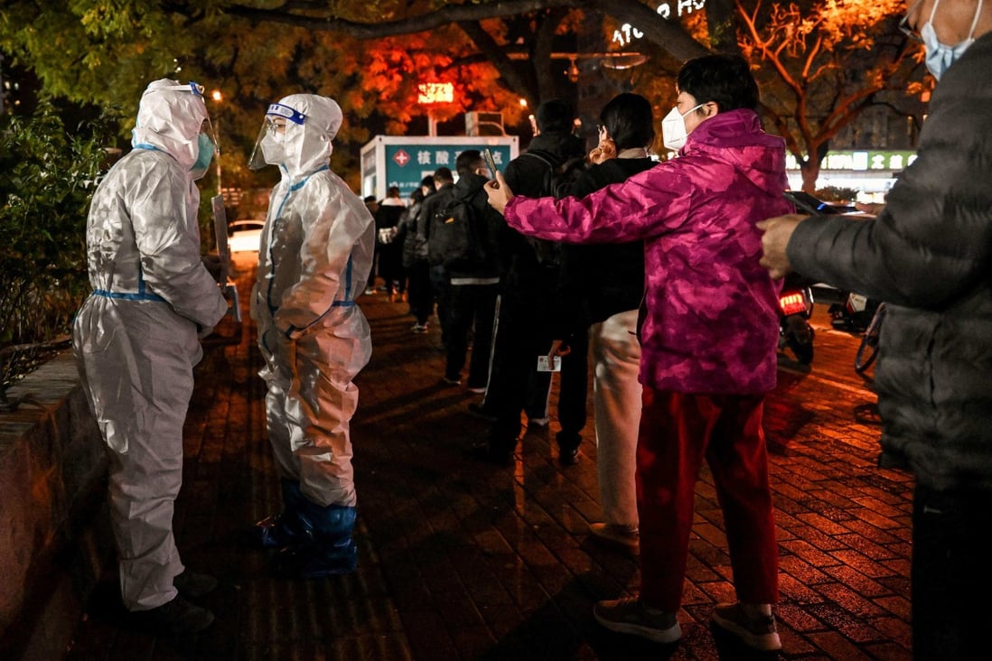 People queue to test for Covid-19 at a swab collection station in Beijing on Tuesday. Photo: AFP