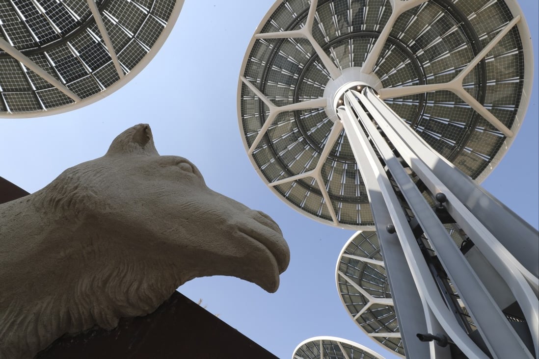 Solar energy trees are seen next to a camel sculpture at Terra, The Sustainability Pavilion, during a media tour at the Dubai World Expo site in the UAE on January 16, 2021. Climate change remains a deep threat but Dubai is rising to the challenge. AP: Photo