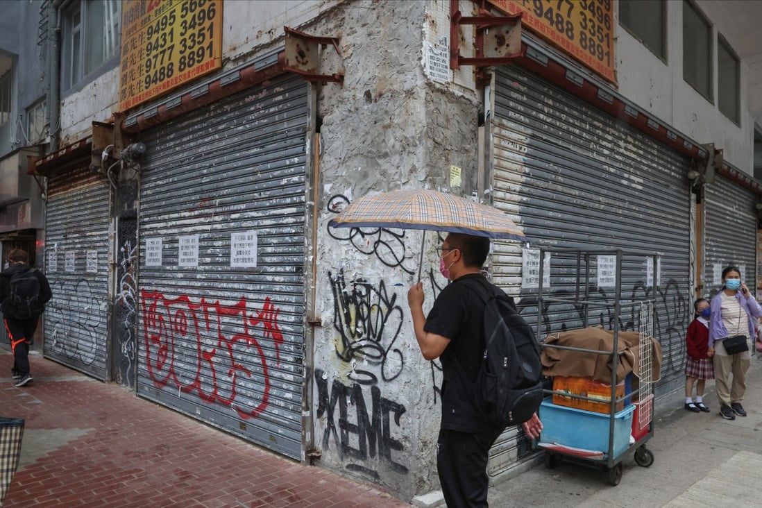People walk past closed shops in Mong Kok. Some distressed owners are selling their units at heavily discounted prices as the segment shows no signs of improving. Photo: Edmond So