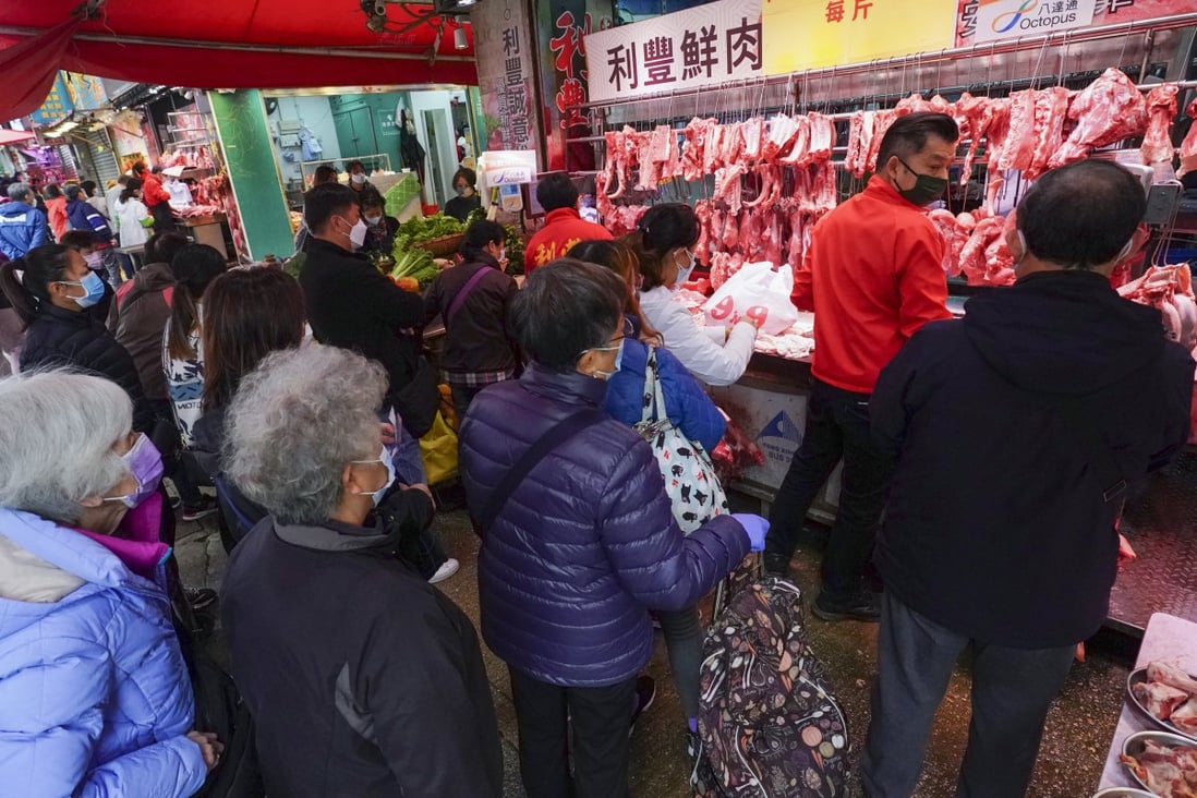 People queue up to buy meat at a wet market on February 25. Photo: Felix Wong