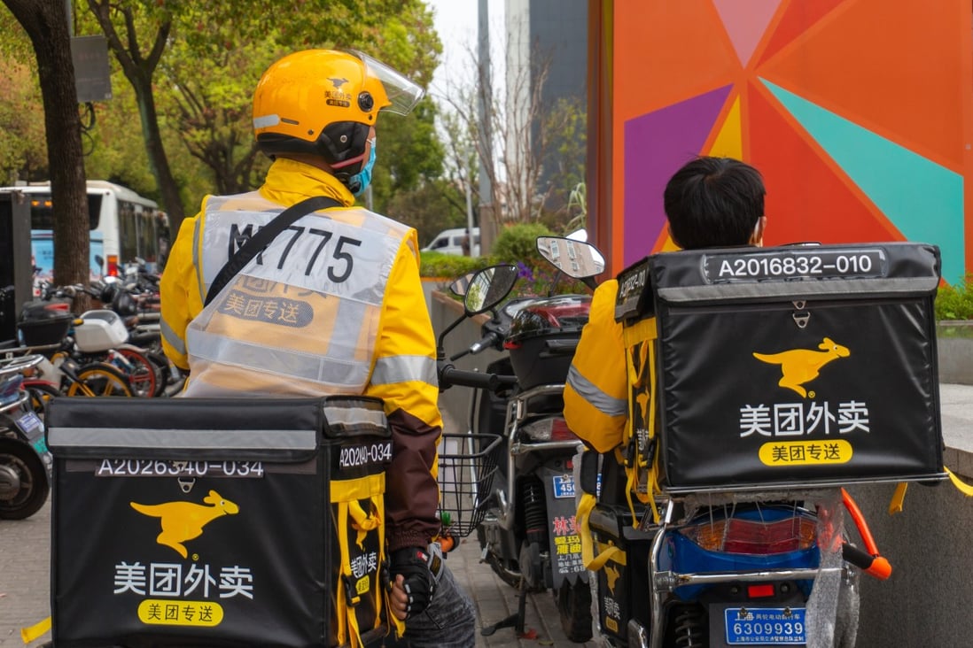 Delivery drivers from Meituan wait for orders beside a shopping mall. Photo: Shutterstock