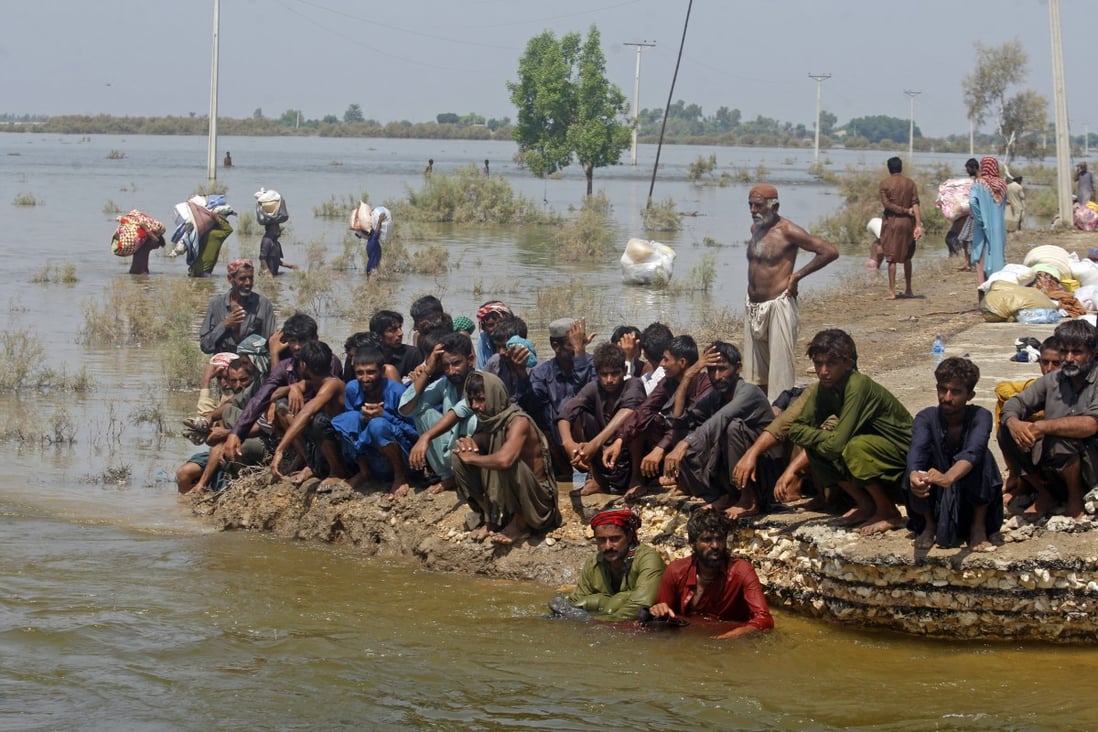 Victims of heavy flooding from monsoon rains wait to receive relief aid from the Pakistani Army in Sindh Province, Pakistan, in September. Photo: AP