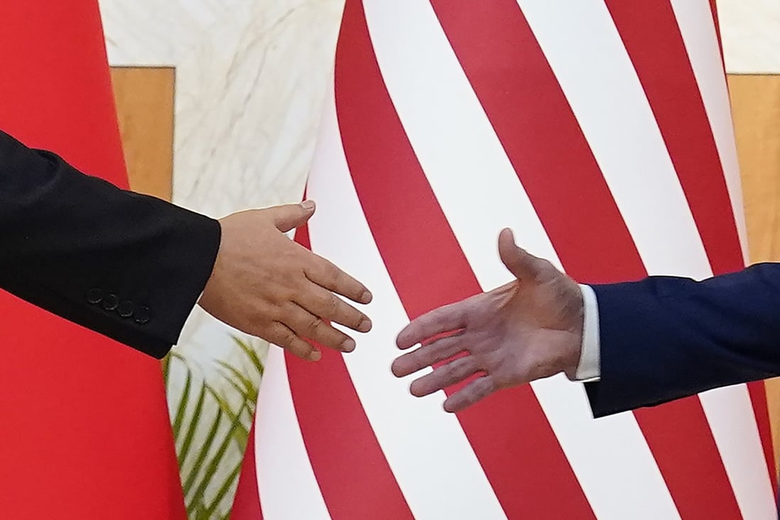 US President Joe Biden and Chinese President Xi Jinping reach out to shake hands before their meeting on the sidelines of the G20 summit on November 14 in Nusa Dua, Bali, Indonesia. Photo: AP