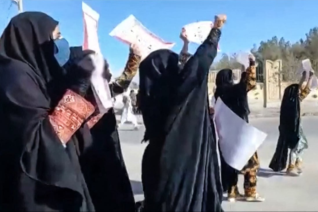 Women march with anti-regime placards in the city of Zahedan in Iran on November 25. Protests have been taking place for weeks, with hundreds of people killed, including dozens of children. Photo: Video screen grab via AFP