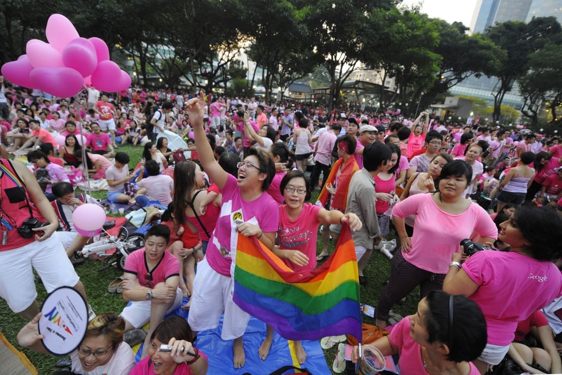 People wave a rainbow flag at the Pink Dot pride rally in Singapore in June 2013. File photo: AP 