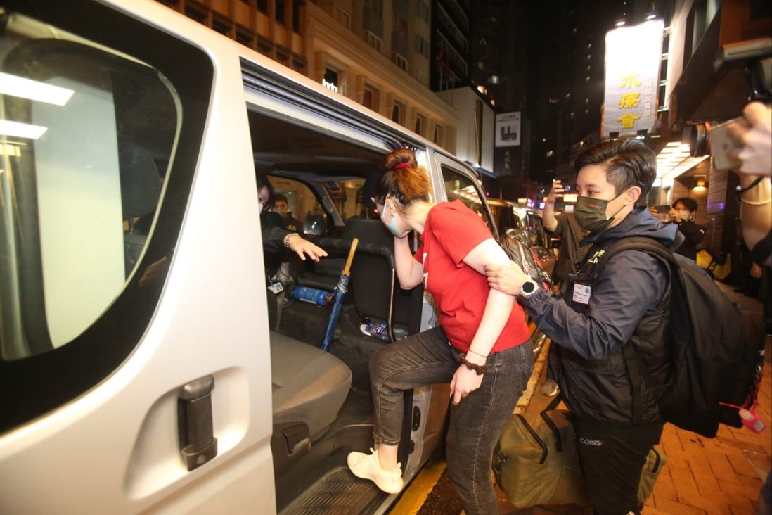 A suspect being escorted into a police van at Kimberley Hotel in Tsim Sha Tsui. Photo: Handout A suspect being escorted into a police van at Kimberley Hotel in Tsim Sha Tsui. Photo: Handout