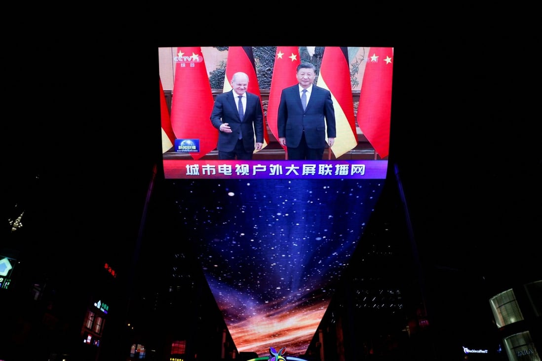 A screen broadcasts a  Chinese state media news segment about German Chancellor Olaf Scholz meeting with Chinese leader Xi Jinping in Beijing on November 4. Photo: Reuters