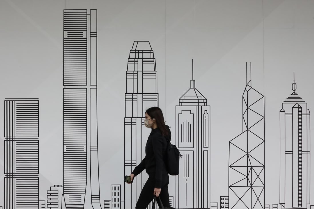 A person walks by a billboard of Hong Kong skyscrapers in Wan Chai on January 13. Photo: Jonathan Wong
