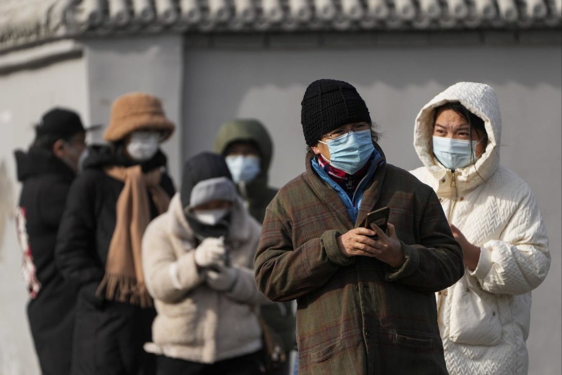 Residents stand in line for their routine COVID-19 tests in freezing cold weather in Beijing on November 29. Chinese universities are sending students home as the Communist Party tries to prevent more zero-Covid protests. Photo: AP 
