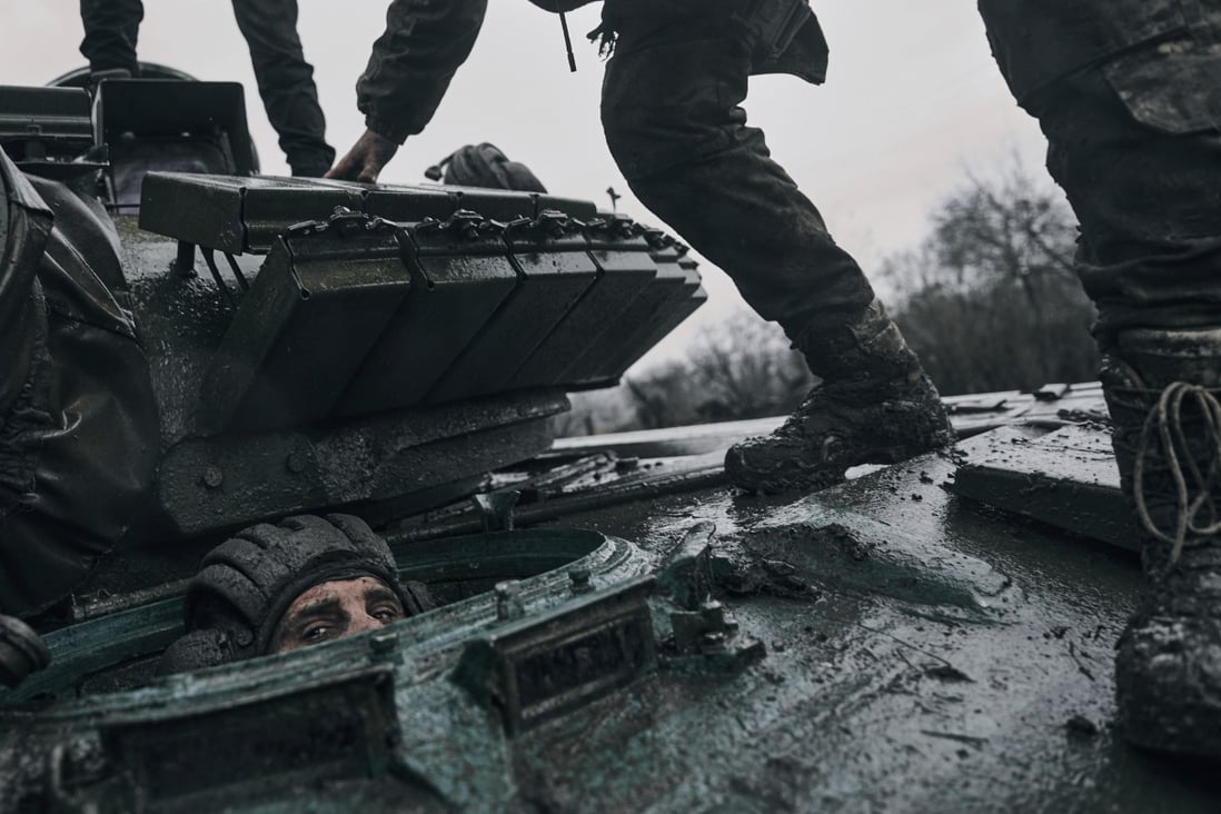 A Ukrainian soldier peers out of a captured Russian tank at the front line in the Donetsk region, Ukraine. Photo: AP