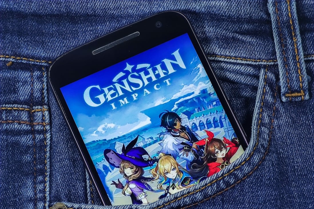 In this photo illustration taken March 26, 2021, a Genshin Impact logo is seen displayed on a smartphone. Photo: Shutterstock Images