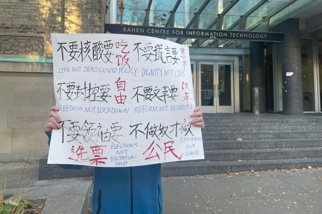 A University of Toronto student from mainland China holds a sign protesting Beijing policies. Photo: Handout